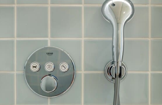 bliss & spa bathroom at Bayline, Armação de Pêra: thermostatic shower controls and hand shower on blue tiles
