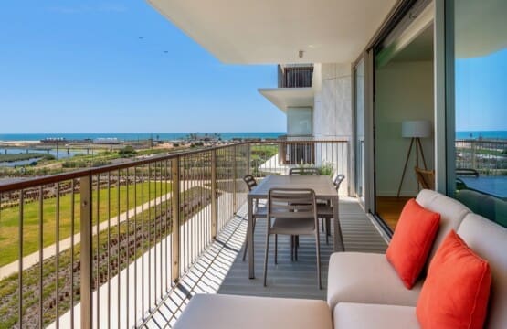 bliss & spa balcony at Bayline, Armação de Pêra: lounge sofa with coral cushions and dining table, view towards the sea
