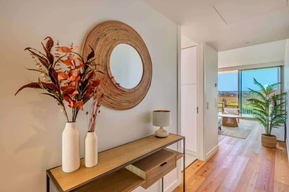 bliss & spa at Bayline, Armação de Pêra: entrance console with dried flowers and rattan mirror, living room beyond