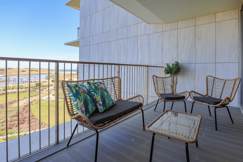 Salmão balcony at Bayline, Armação de Pêra: rattan lounge set with a view over the lagoon towards the sea