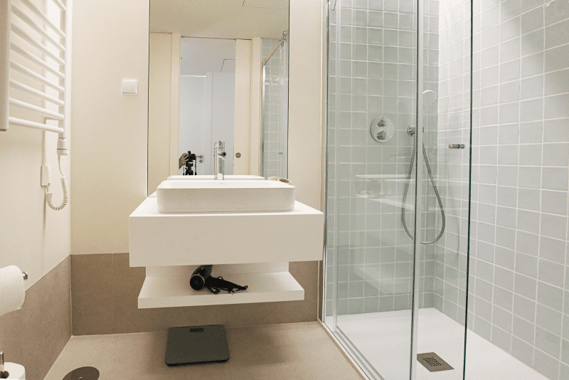 Cavala bathroom at Bayline, Armação de Pêra: vessel basin on a floating shelf and glass walk-in shower