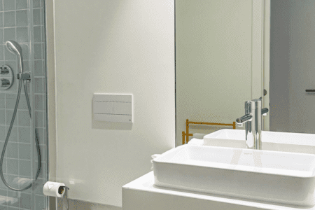 Robalo bathroom at Bayline, Armação de Pêra: vessel basin on a floating shelf, wall-hung toilet and shower