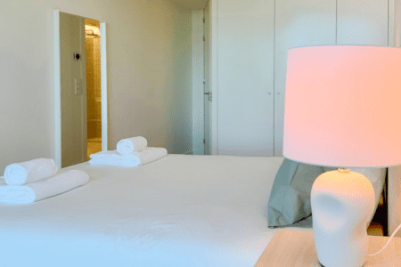 Robalo bedroom at Bayline, Armação de Pêra: double bed with rolled towels, ceramic lamp and built-in wardrobe