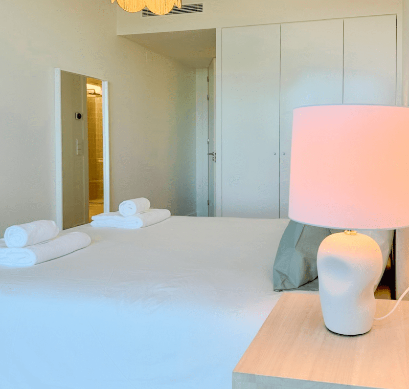 Robalo bedroom at Bayline, Armação de Pêra: double bed with rolled towels, ceramic lamp and built-in wardrobe
