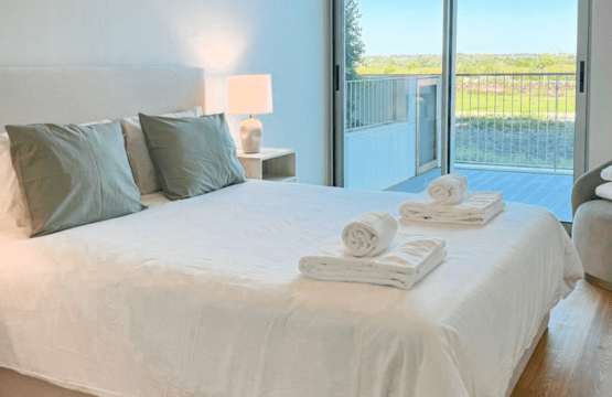 Robalo bedroom at Bayline, Armação de Pêra: double bed with sage cushions and glass door to the balcony