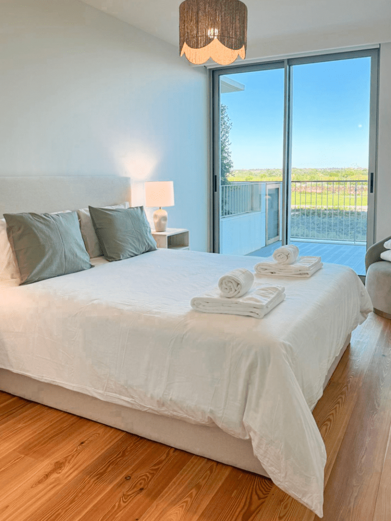 Robalo bedroom at Bayline, Armação de Pêra: double bed with sage cushions and glass door to the balcony