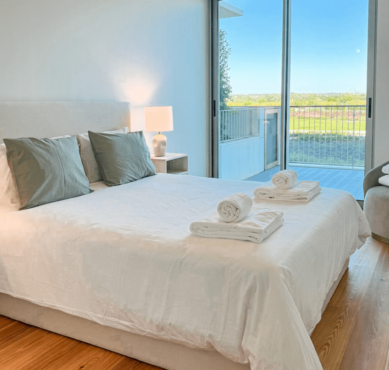 Robalo bedroom at Bayline, Armação de Pêra: double bed with sage cushions and glass door to the balcony