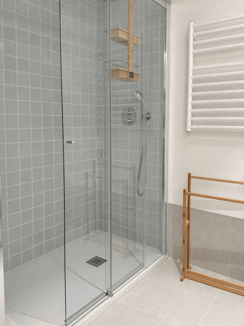 Robalo bathroom at Bayline, Armação de Pêra: glass walk-in shower with grey tiles and heated towel rail