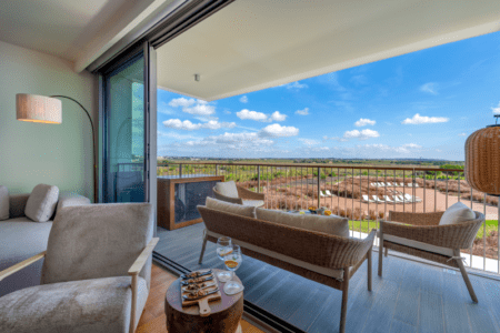 Raia balcony at Bayline, Armação de Pêra: rattan lounge set with a wide view over the countryside