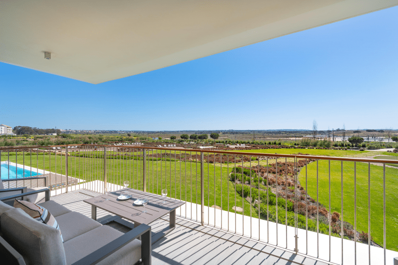 Enguia balcony at Bayline, Armação de Pêra: lounge set with a wide view over the pool and gardens