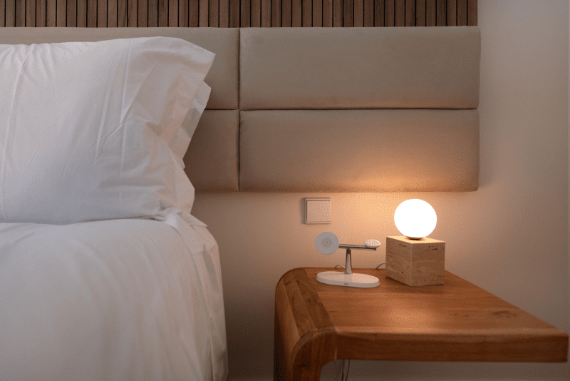 Sardinha bedroom at Bayline, Armação de Pêra: upholstered headboard, wooden bedside table and globe lamp