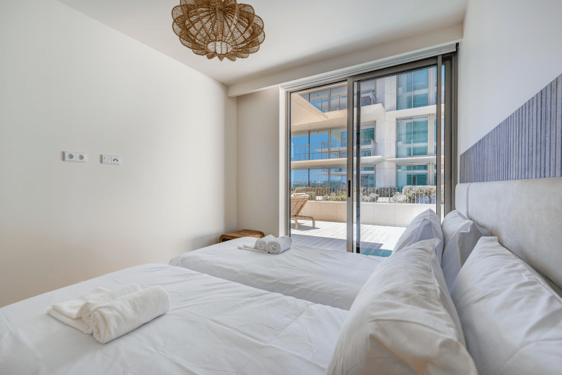 Sardinha bedroom at Bayline, Armação de Pêra: beds with white linen and sliding door to the terrace