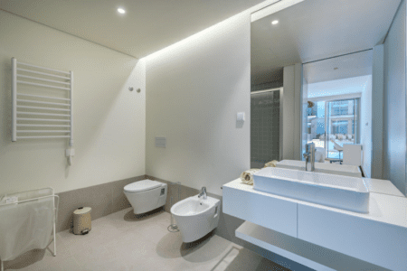 Sardinha bathroom at Bayline, Armação de Pêra: vessel basin, wall-hung toilet, bidet and heated towel rail