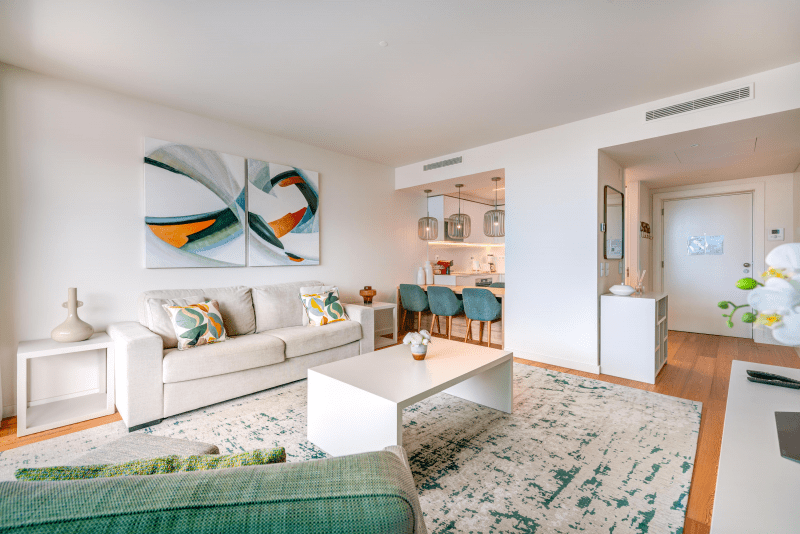 Safia at Bayline, Armação de Pêra: living room with sofa and coffee table, dining area and entrance beyond