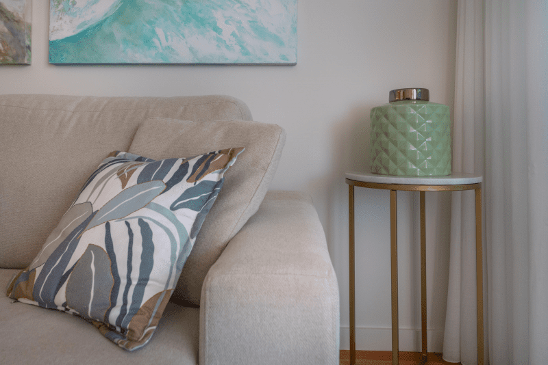Liro living room at Bayline, Armação de Pêra: armchair with leaf-print cushion beside a side table