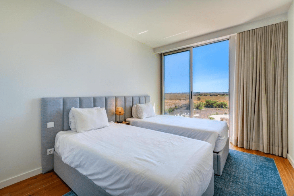 Nemo bedroom at Bayline, Armação de Pêra: two single beds and floor-to-ceiling window onto the countryside