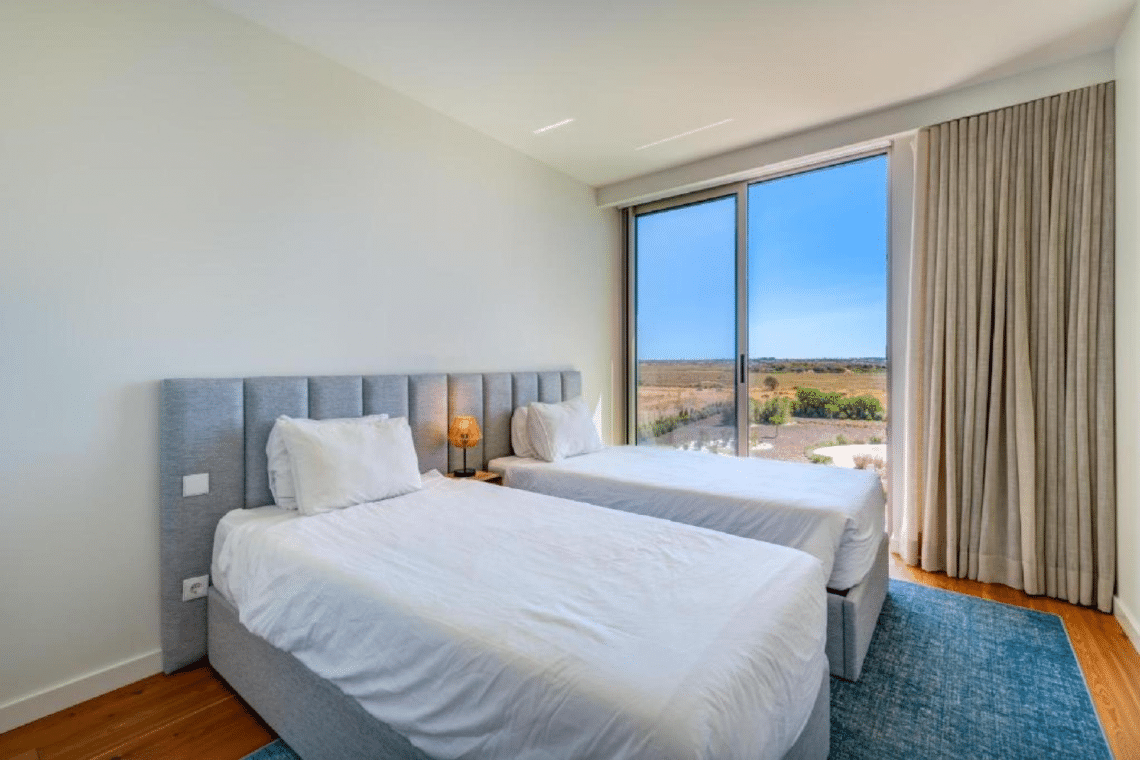 Nemo bedroom at Bayline, Armação de Pêra: two single beds and floor-to-ceiling window onto the countryside