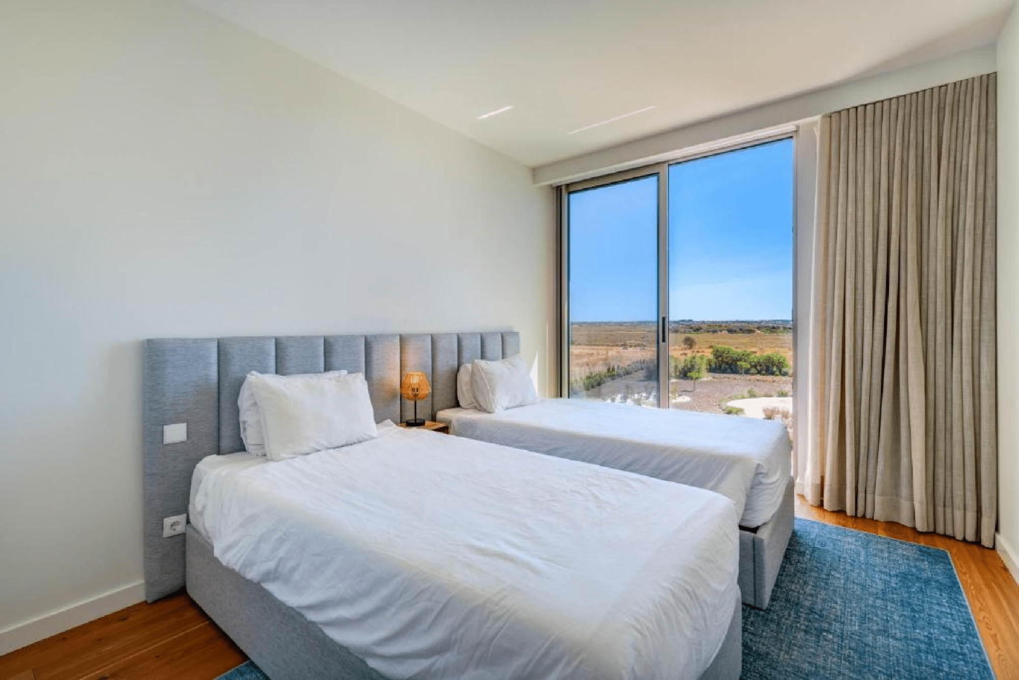 Nemo bedroom at Bayline, Armação de Pêra: two single beds and floor-to-ceiling window onto the countryside